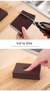Macro detail showing scissors cutting the flexible emery sponge for custom kitchen cleaning
