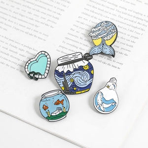 Macro view of five Van Gogh style enamel pins featuring whale and starry night art