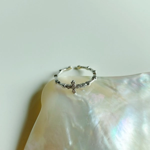 Macro detail of S925 sterling silver cross ring with sparkling zircon inlays