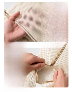 Detail of fine mesh fabric and durable zinc alloy zipper on double-layer laundry bag
