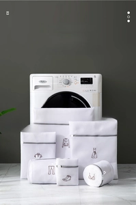 Detailed set of white mesh laundry bags with grey zippers and clothing icons on a washer