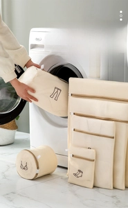 Detail of multi-size mesh laundry bags with embroidery icons and reinforced zippers