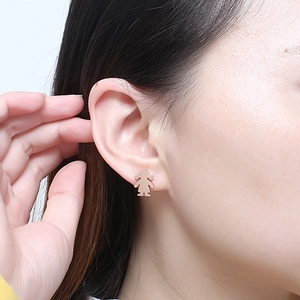 Elegant rose gold plated little girl silhouette stud earrings on model's ear