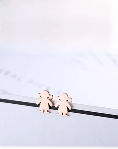 Macro view of rose gold cartoon girl silhouette earrings with polished finish