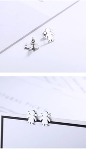 Detail showing front and back view of silver girl shaped stainless steel stud earrings