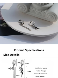 Detail view of retro asymmetric earrings showing weight and plated alloy texture