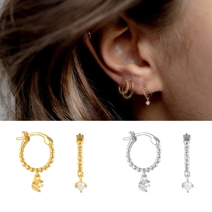 Detail of S925 sterling silver bead earrings with sparkling cubic zirconia charms