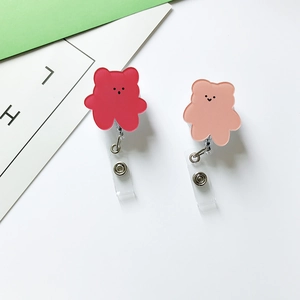 Close-up of red and pink bear retractable badge holders for nurses and doctors