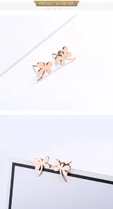 Close-up of dragonfly stud earrings in polished rose gold with needle pin structure