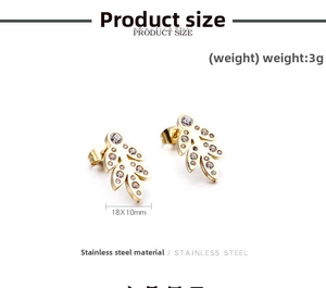 Macro detail of leaf-shaped gold stainless steel stud earrings with cubic zirconia stones
