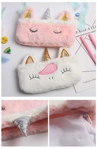 Detail of plush unicorn pencil case showing soft faux fur and metallic horn texture
