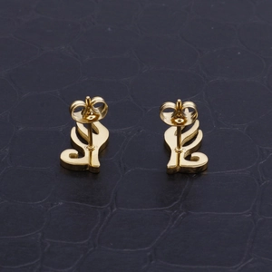 Minimalist golden hollow angel wing stud earrings displayed on a black leather background