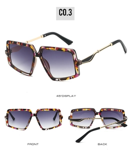 Detail view of square oversized sunglasses with colorful frame and purple gradient lenses
