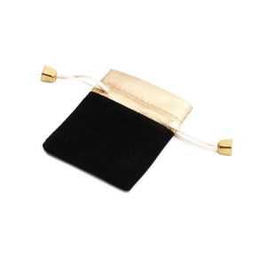 Close-up of a premium black velvet jewelry pouch with a gold drawstring top for necklaces