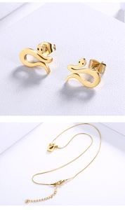 Close-up of a gold snake-shaped stud earring set and matching pendant necklace