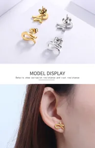 Detailed view of gold and silver snake earrings with high polish and rust resistance