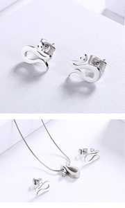 Detailed view of silver snake-shaped stud earrings and matching pendant necklace set