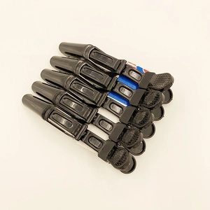 Detail of 6 black professional hair sectioning clips with non-slip grip and hinge design