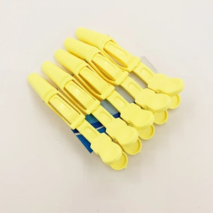 Set of 6 yellow professional hair sectioning crocodile clips on display card