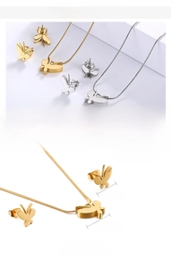 Detailed view of butterfly necklace and stud earrings set in gold and steel finish
