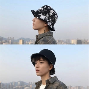 Close-up of double-sided reversible bucket hat with black and white palm tree print pattern
