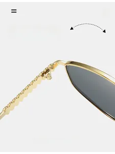 Close-up of durable golden metal hinges with wavy texture on vintage oval sunglasses