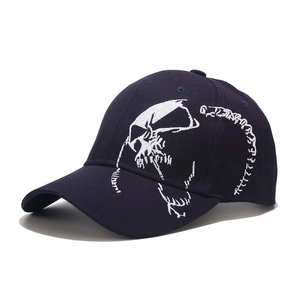 Detail of navy cotton baseball cap featuring white skull skeleton embroidery on the side