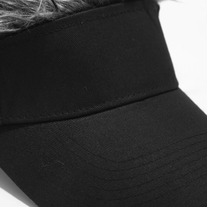 Detail of creative black baseball cap with grey synthetic hair on top for street style