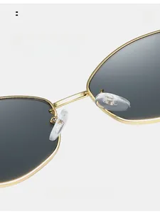 Detailed close-up of golden metal frame sunglasses with comfortable silicone nose pads