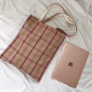 Minimalist pink plaid canvas tote bag with cotton handles shown with a laptop