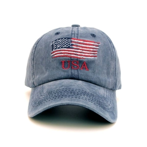 Close-up of USA embroidery and American flag on blue washed cotton baseball cap
