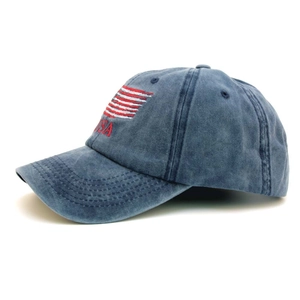 Detail of USA embroidery and red stripes on vintage washed blue cotton baseball cap