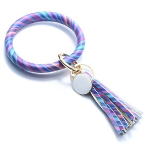 Detail of colorful spiral pattern PU leather wristlet keychain with gold ring and tassel