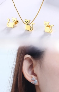 Detail view of cute cat silhouette jewelry set in gold and silver showing on models