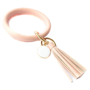 Detailed view of pink PU leather wristlet keychain with tassel and white round pendant