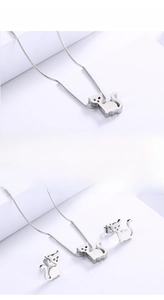 Macro detail of silver cat necklace and earrings set with 18K gold plated steel