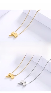 Detail of 18K gold and silver plated four-leaf clover necklaces on snake chains