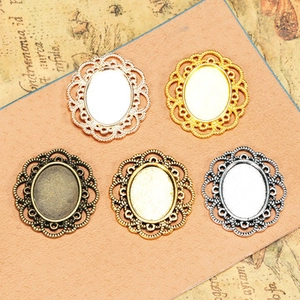 Detailed macro view of vintage hollow lace metal pendants in five various colors