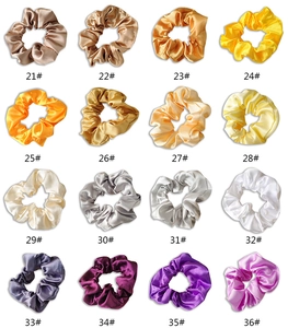 Detailed color chart of 16 premium satin scrunchies featuring glossy silk texture