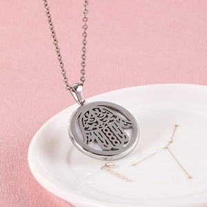 Collier avec pendentif Main de Fatma en acier inoxydable sur un plateau à bijoux chic