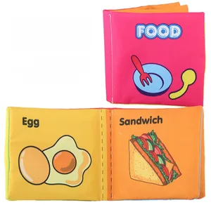Macro detail of educational baby cloth book showing colorful food patterns and English words