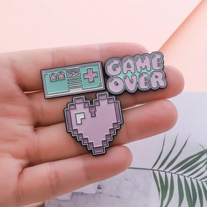 Retro pixel game pins set featuring gamepad, purple heart and Game Over text badges