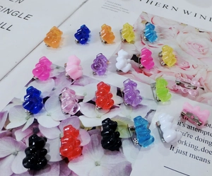 Flat lay detail of multi-colored resin gummy bear brooches with metal pin backs