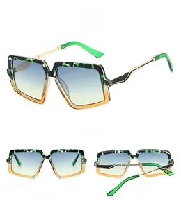 Detail view of square sunglasses with camo and orange frame plus metal temples