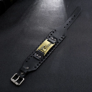 Detail of black leather wide bracelet with bronze axe and hammer buckle design