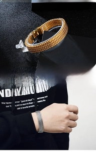 Detail of gold and steel men's woven keel bracelets with secure rectangular clasps