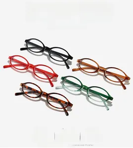 Flat lay of oval anti-blue light glasses in black, red, tortoise, amber, and green