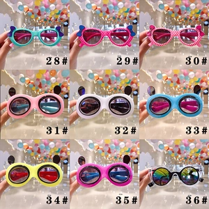 Close-up of nine kids cartoon sunglasses styles featuring polka dot bows and cat ears