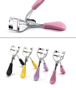 Detail view of colorful eyelash curlers with metal frames and soft silicone pads