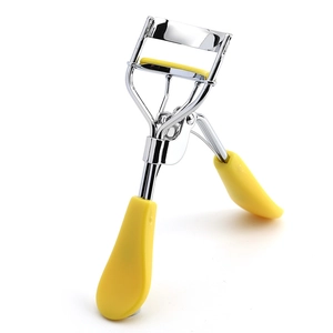 Detail view of the silver metal eyelash curler with yellow plastic anti-slip handle grip